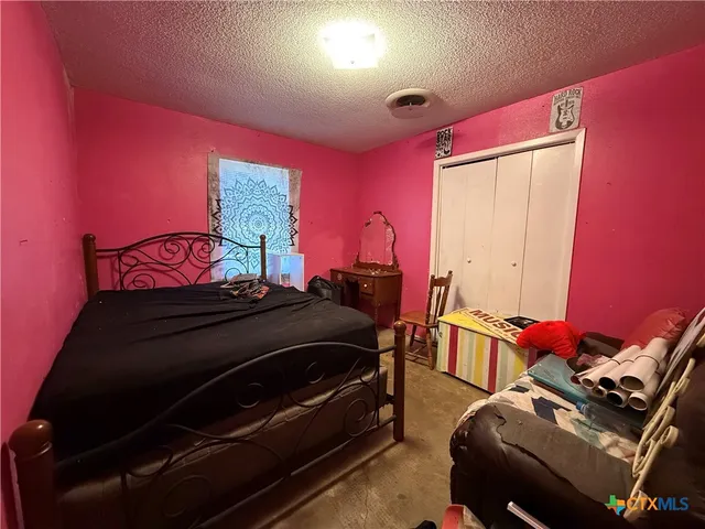 a bedroom with furniture and a dresser