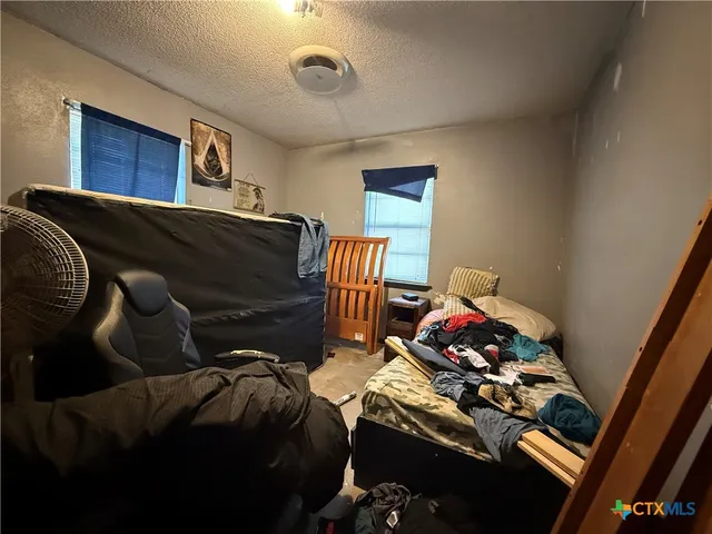 a bedroom with two beds and a chandelier