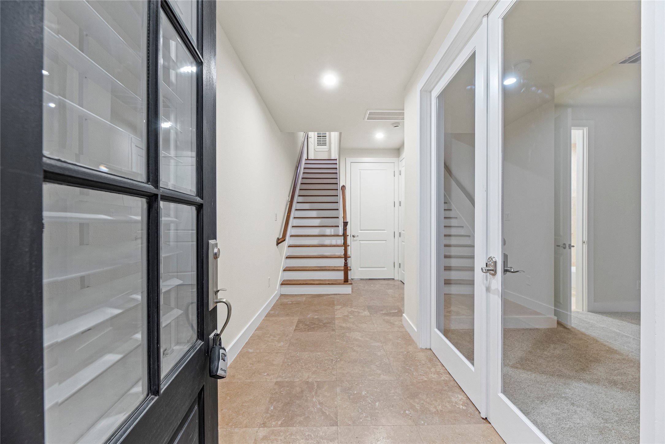 2513 B Garrow Street Houston, TX 77003 - Photo 6 of 29 Gorgeous entry with tile flooring and a wooden staircase.
