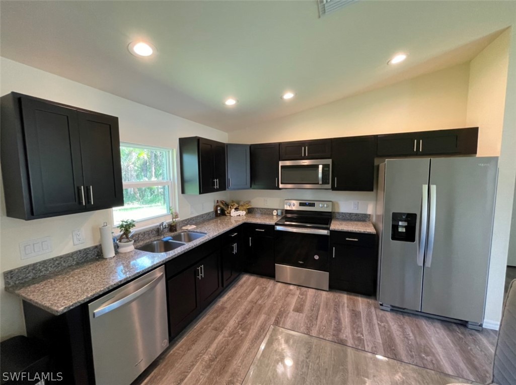 5010 Sun Court LaBelle, FL 33935 - Photo 11 of 20 a kitchen with stainless steel appliances granite countertop a sink counter space cabinets and stainless steel appliances