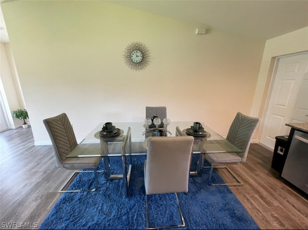 5010 Sun Court LaBelle, FL 33935 - Photo 12 of 20 a view of a dining room with furniture and wooden floor