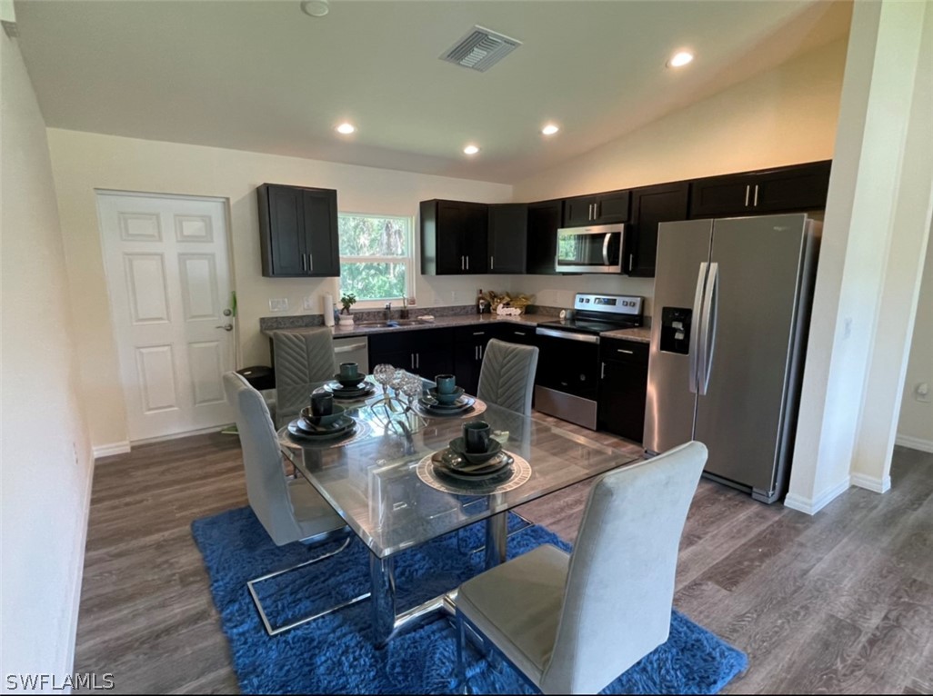 5010 Sun Court LaBelle, FL 33935 - Photo 9 of 20 a dining room with furniture a window and a kitchen view