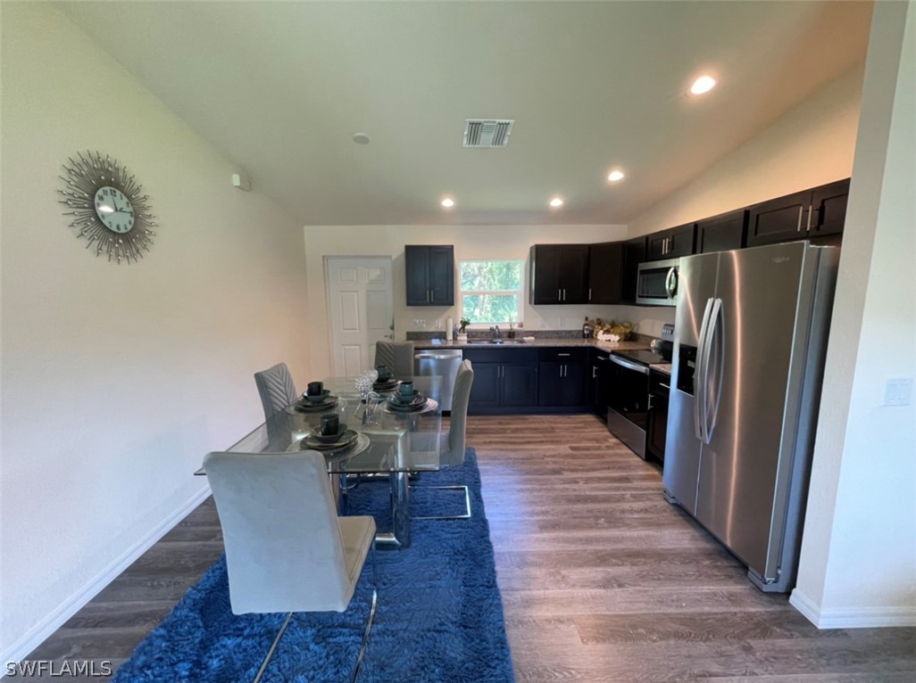 5010 Sun Court LaBelle, FL 33935 - Photo 10 of 20 a living room with stainless steel appliances furniture a rug and a kitchen view