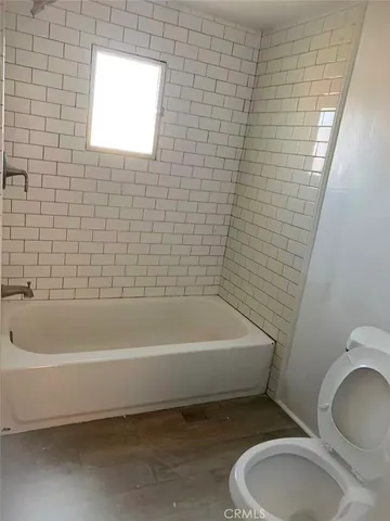 a bathroom with a sink a toilet and bathtub