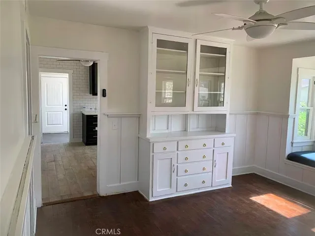 a view of kitchen with granite countertop cabinets and window
