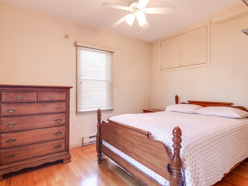 5 White Way Rockport, MA 01966 - Photo 18 of 41 a bedroom with a bed and a chandelier