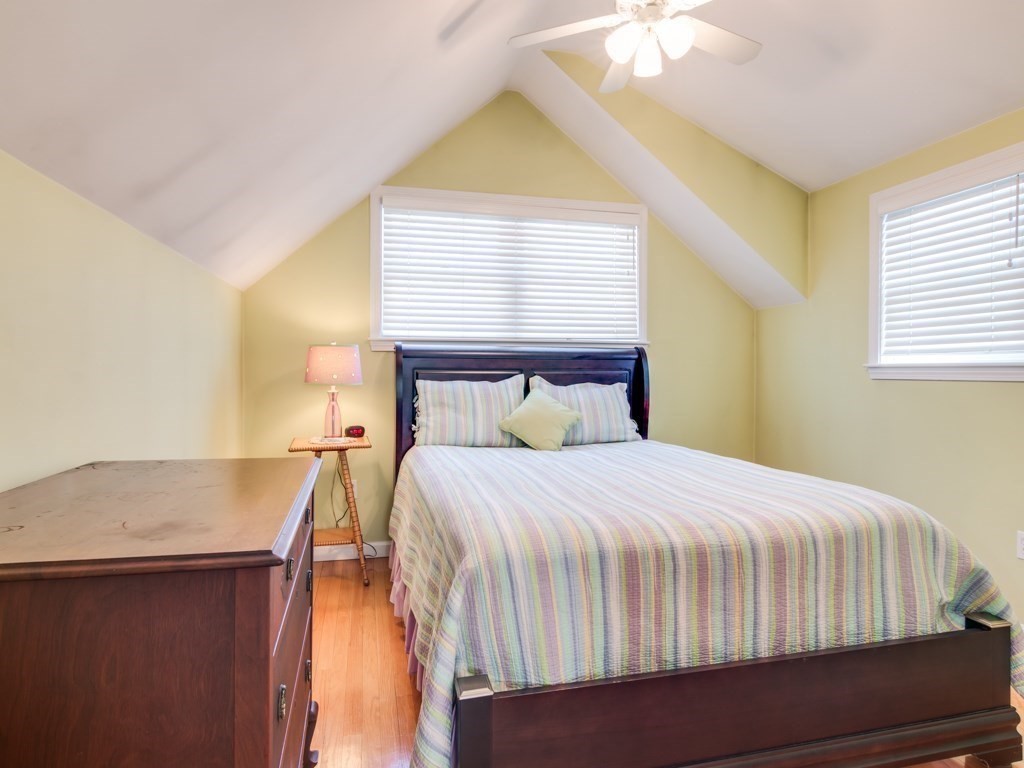 5 White Way Rockport, MA 01966 - Photo 24 of 41 a bedroom with a bed and a chandelier