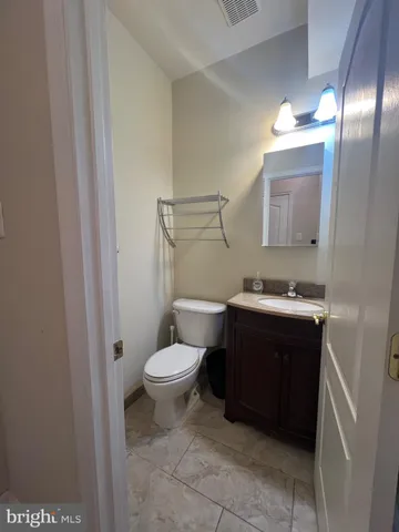 a bathroom with a shower sink vanity and mirror