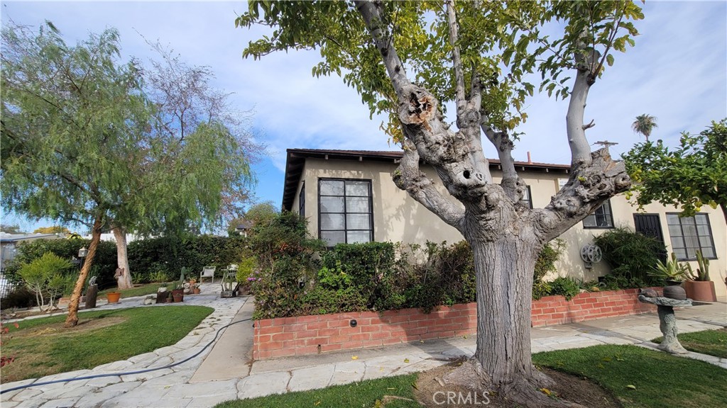 2701 Berkeley Street Bakersfield, CA 93305 - Photo 1 of 58 a tree in front of a house with a yard