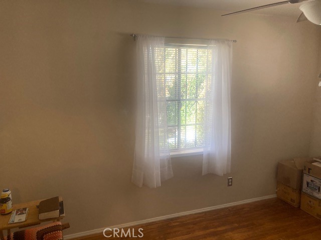 2701 Berkeley Street Bakersfield, CA 93305 - Photo 32 of 58 a view of an empty room with wooden floor and a window