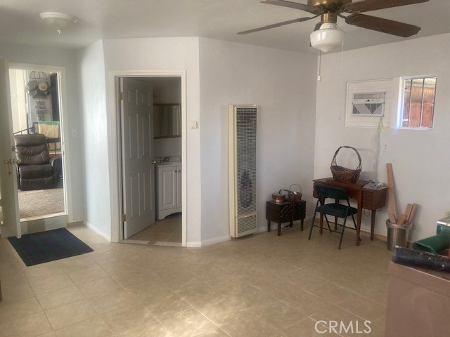 2701 Berkeley Street Bakersfield, CA 93305 - Photo 48 of 58 a view of a workspace with furniture and a chandelier fan