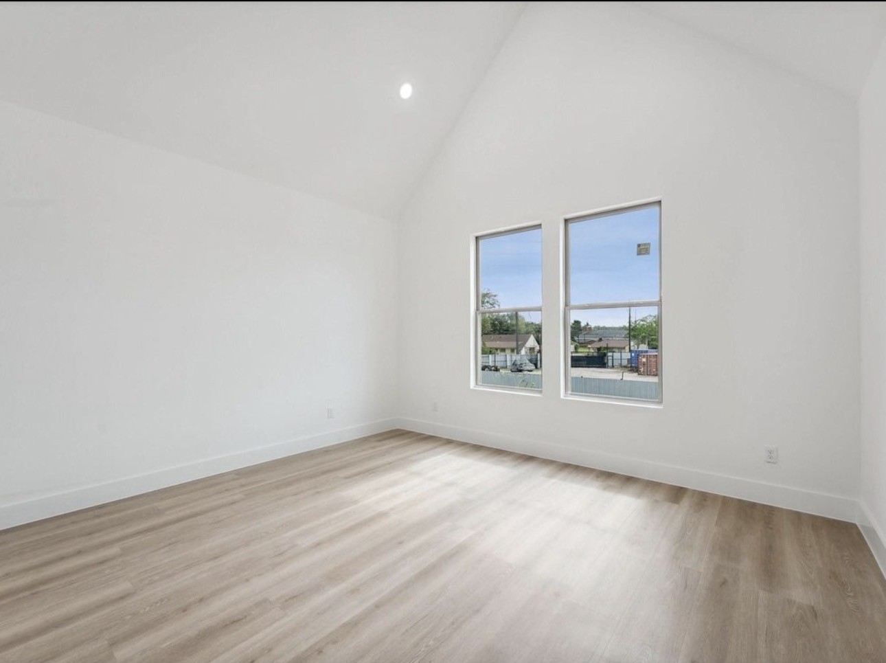 7416 Maxroy Street Houston, TX 77088 - Photo 14 of 35 a view of an empty room with wooden floor and a window