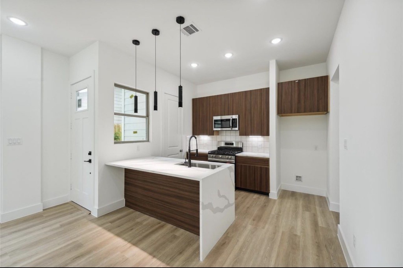 7416 Maxroy Street Houston, TX 77088 - Photo 2 of 35 a kitchen with kitchen island a sink stainless steel appliances and cabinets