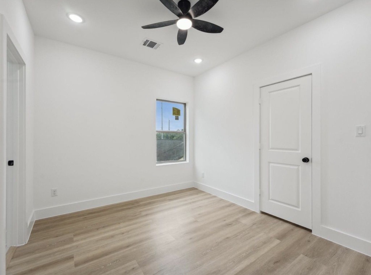 7416 Maxroy Street Houston, TX 77088 - Photo 24 of 35 wooden floor in an empty room with a window