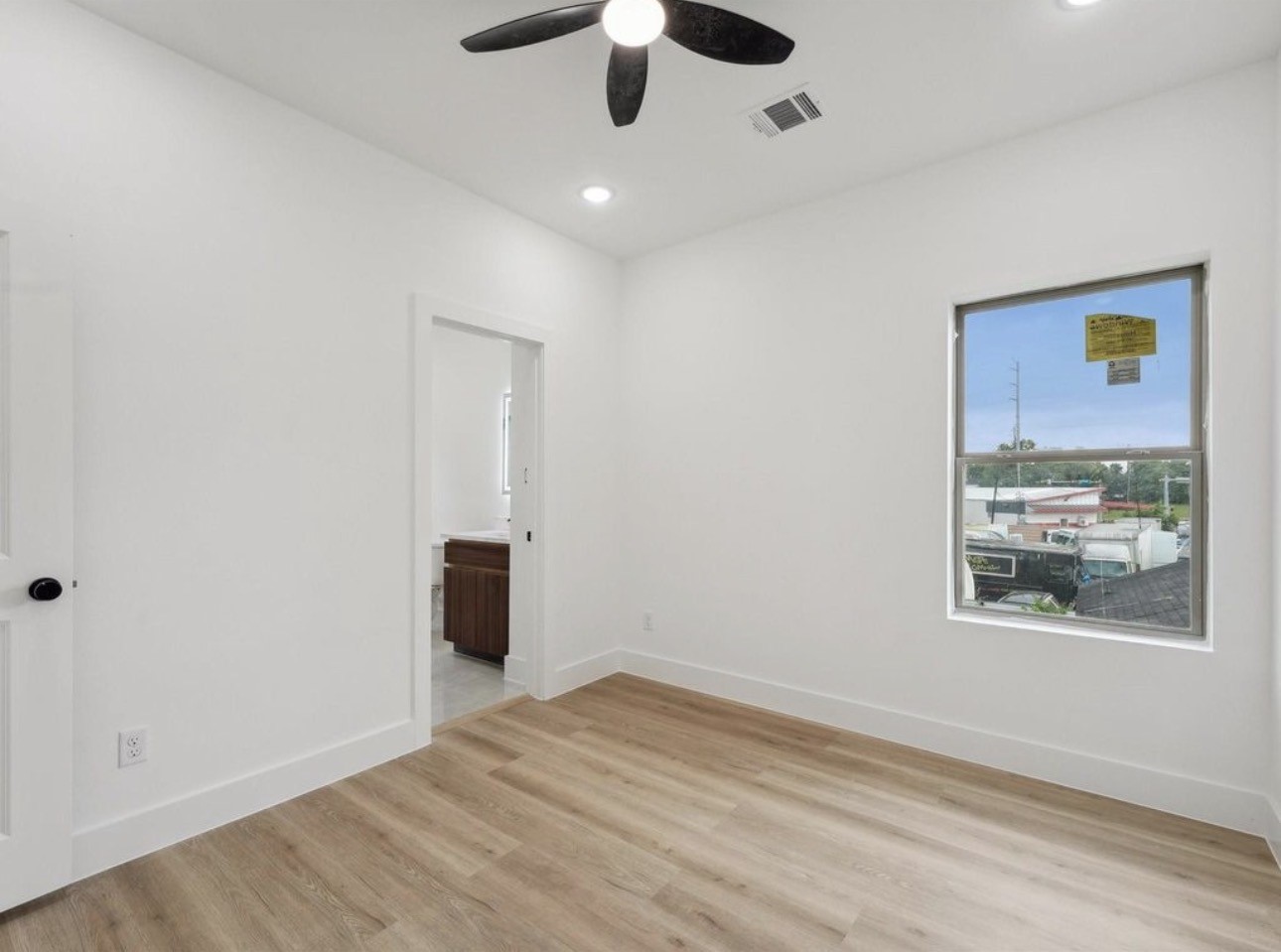7416 Maxroy Street Houston, TX 77088 - Photo 27 of 35 a view of an empty room with window and wooden floor