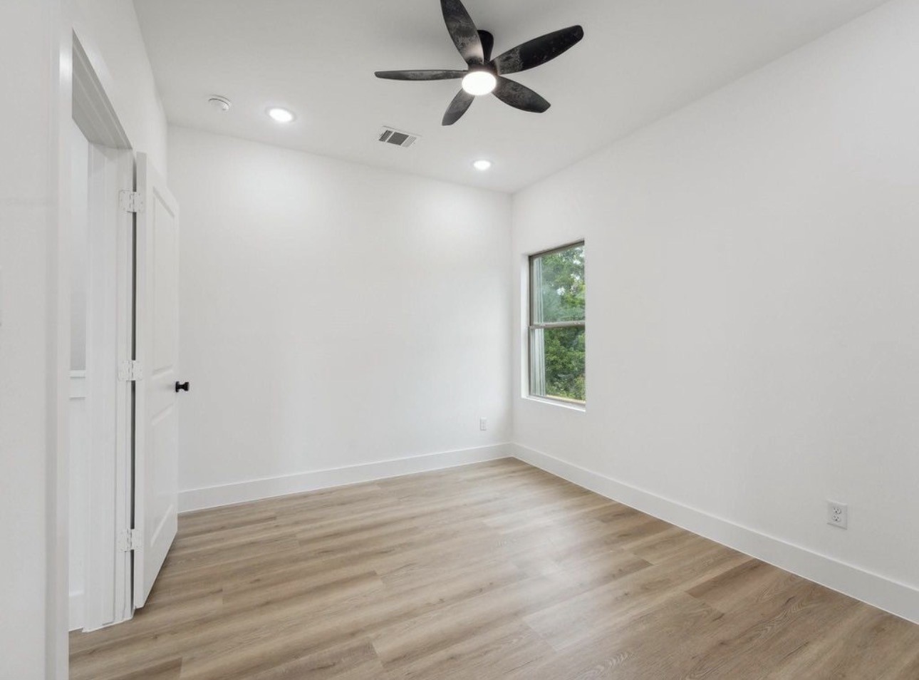 7416 Maxroy Street Houston, TX 77088 - Photo 30 of 35 wooden floor in an empty room with a window