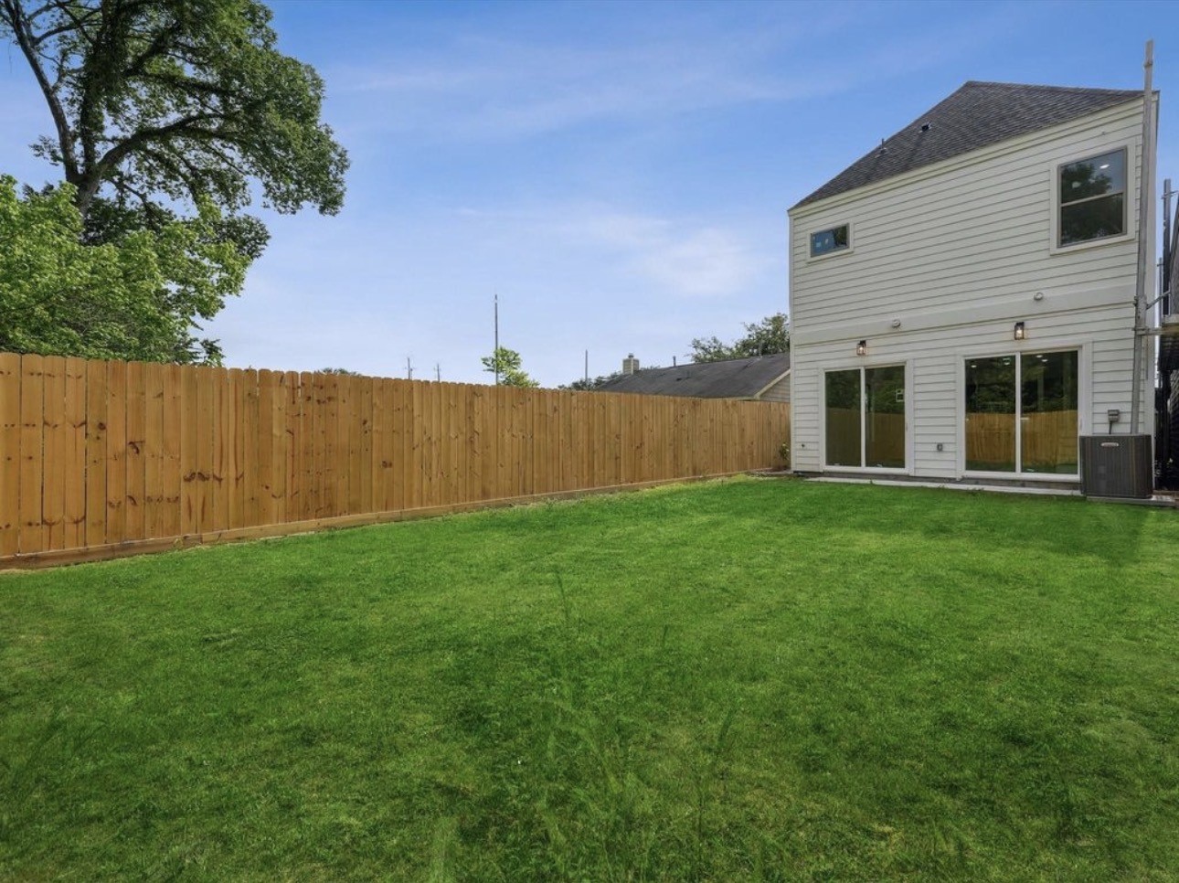 7416 Maxroy Street Houston, TX 77088 - Photo 34 of 35 a view of a backyard with plants and large tree