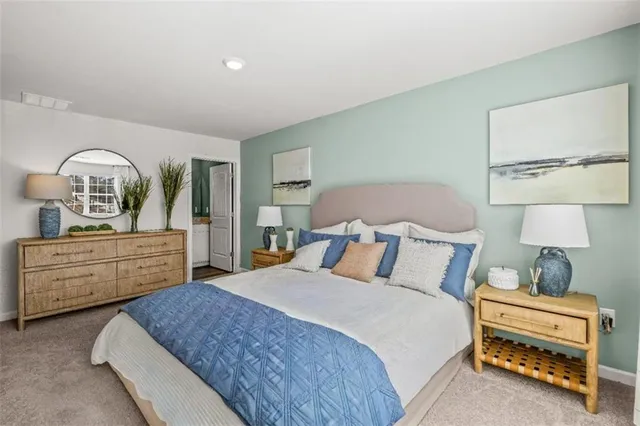 a bedroom with a bed and dresser