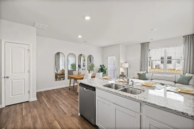 a very nice looking living room with a large window and wooden floors