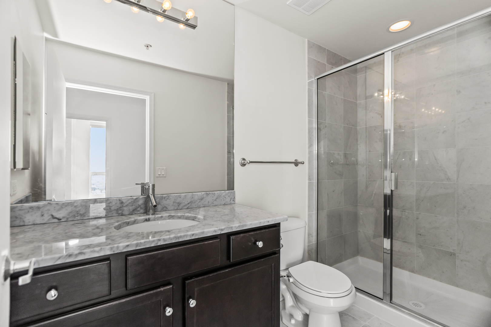 1901 South Calumet Avenue, Unit 2712 Chicago, IL 60616 - Photo 21 of 39 a bathroom with a granite countertop sink toilet and shower