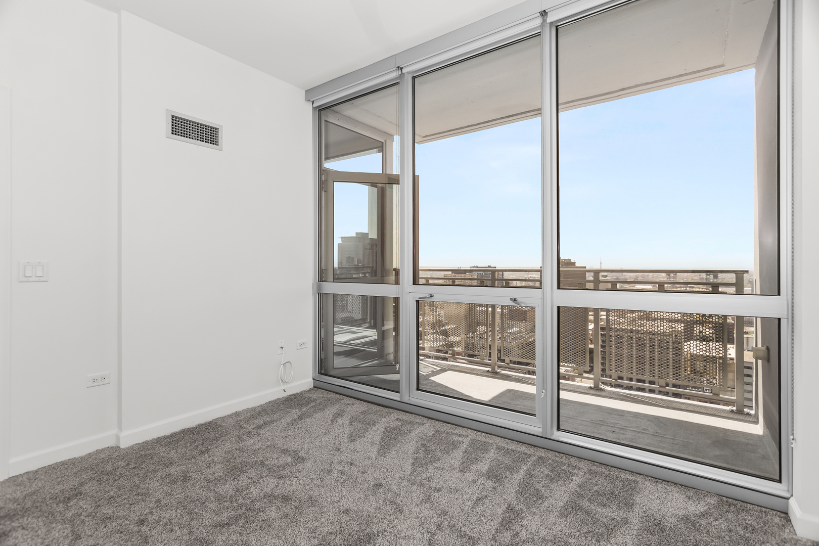 1901 South Calumet Avenue, Unit 2712 Chicago, IL 60616 - Photo 23 of 39 a view of an empty room with a floor to ceiling window and an outdoor view
