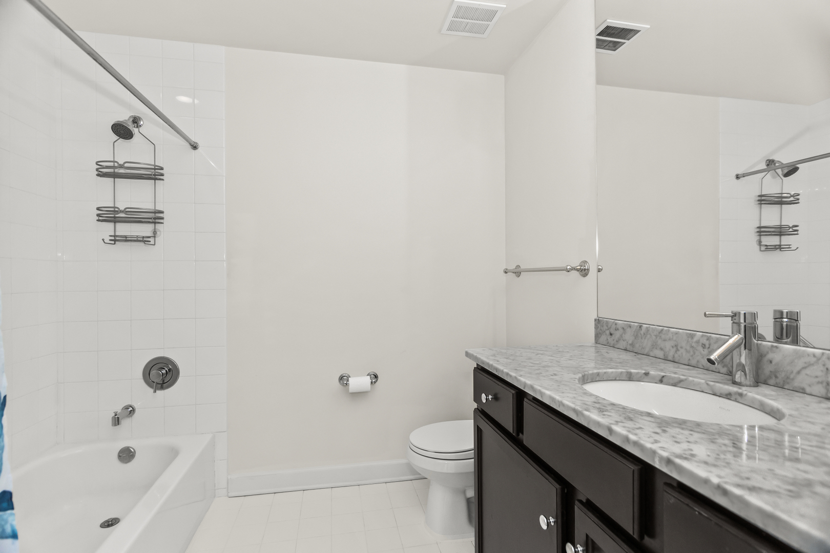 1901 South Calumet Avenue, Unit 2712 Chicago, IL 60616 - Photo 25 of 39 a bathroom with a granite countertop sink a toilet and bathtub