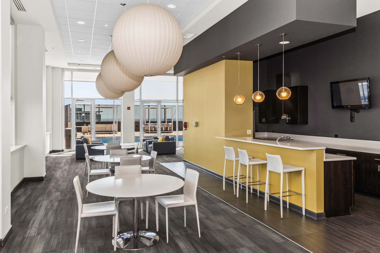 1901 South Calumet Avenue, Unit 2712 Chicago, IL 60616 - Photo 29 of 39 a kitchen with stainless steel appliances kitchen island granite countertop a table chairs and a chandelier