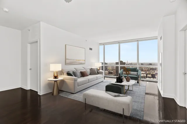 a living room with furniture large window and a table