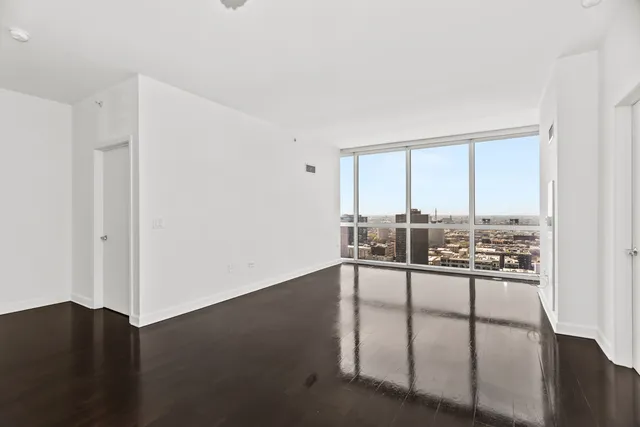 a view of a living room hardwood floor and a ceiling fan