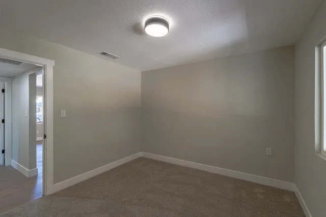 an empty room with windows and entrance