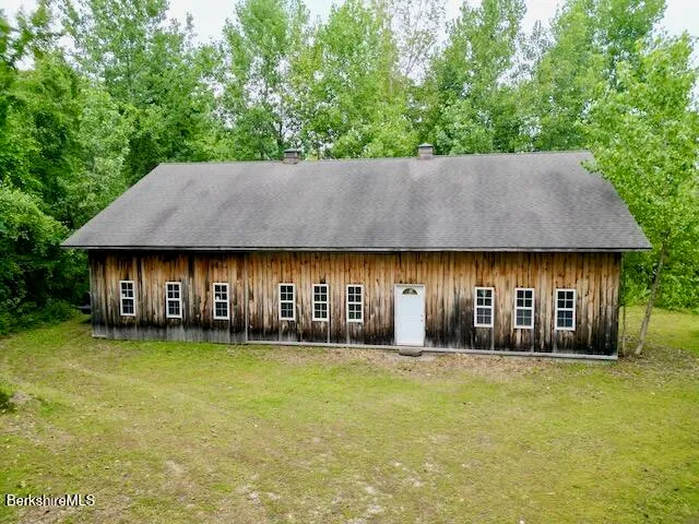 an outdoor view of house and yard with green space