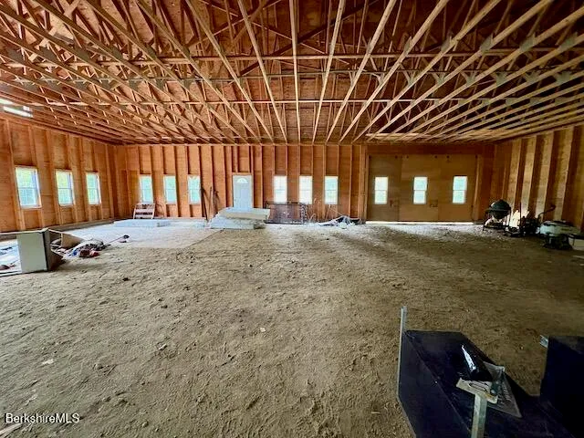 a large room with a large window and couches