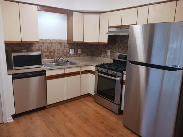 a kitchen with a refrigerator sink and microwave