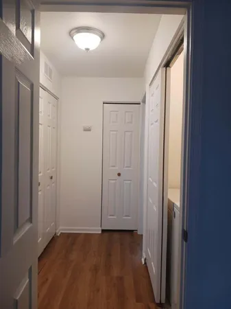 a view of a hallway with wooden floor