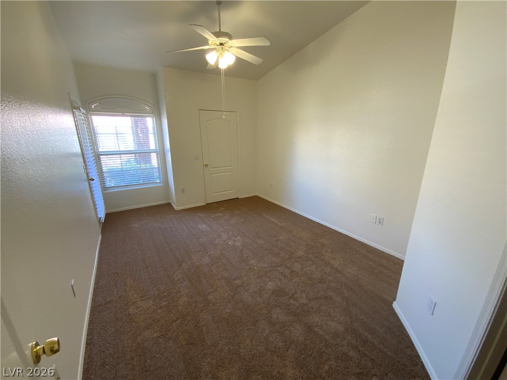 7400 West Flamingo Road, Unit 1039 Las Vegas, NV 89147 - Photo 33 of 40 A quiet bedroom retreat with a warm carpeted floor and an arched window offering natural light.