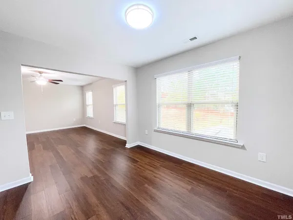a view of empty room with wooden floor