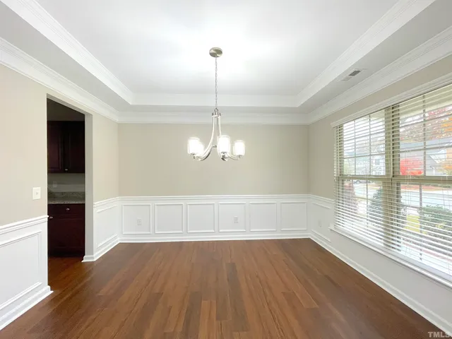 a view of an empty room and wooden floor