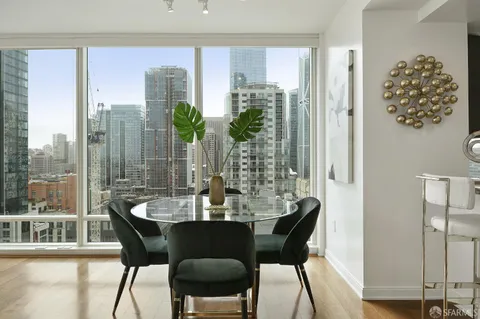 a dining room with furniture a chandelier and wooden floor