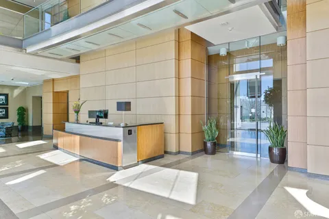 a kitchen with stainless steel appliances kitchen island granite countertop a refrigerator and a sink