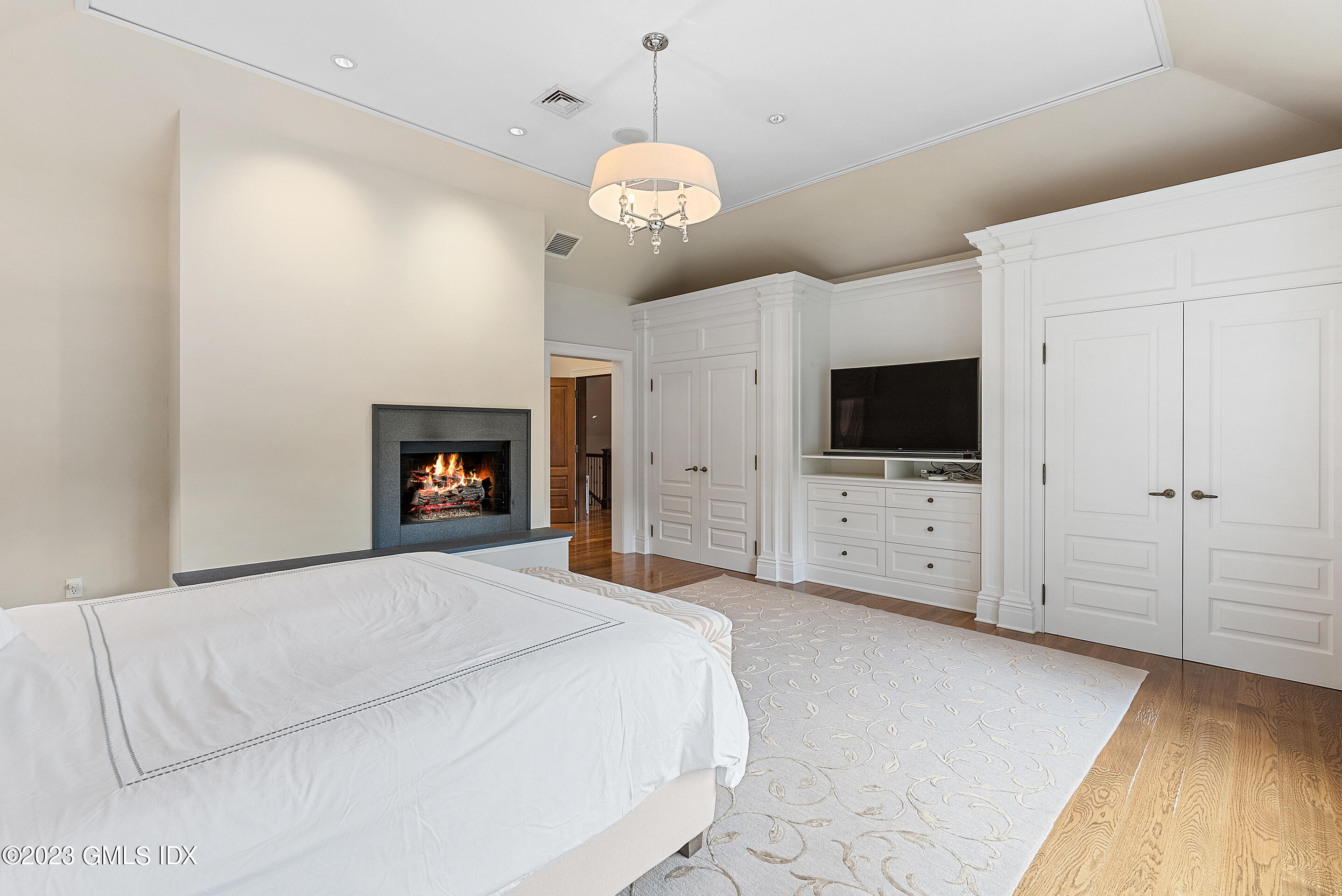 151 Clapboard Ridge Road Greenwich, CT 06831 - Photo 19 of 34 a spacious bedroom with a bed and a flat screen tv