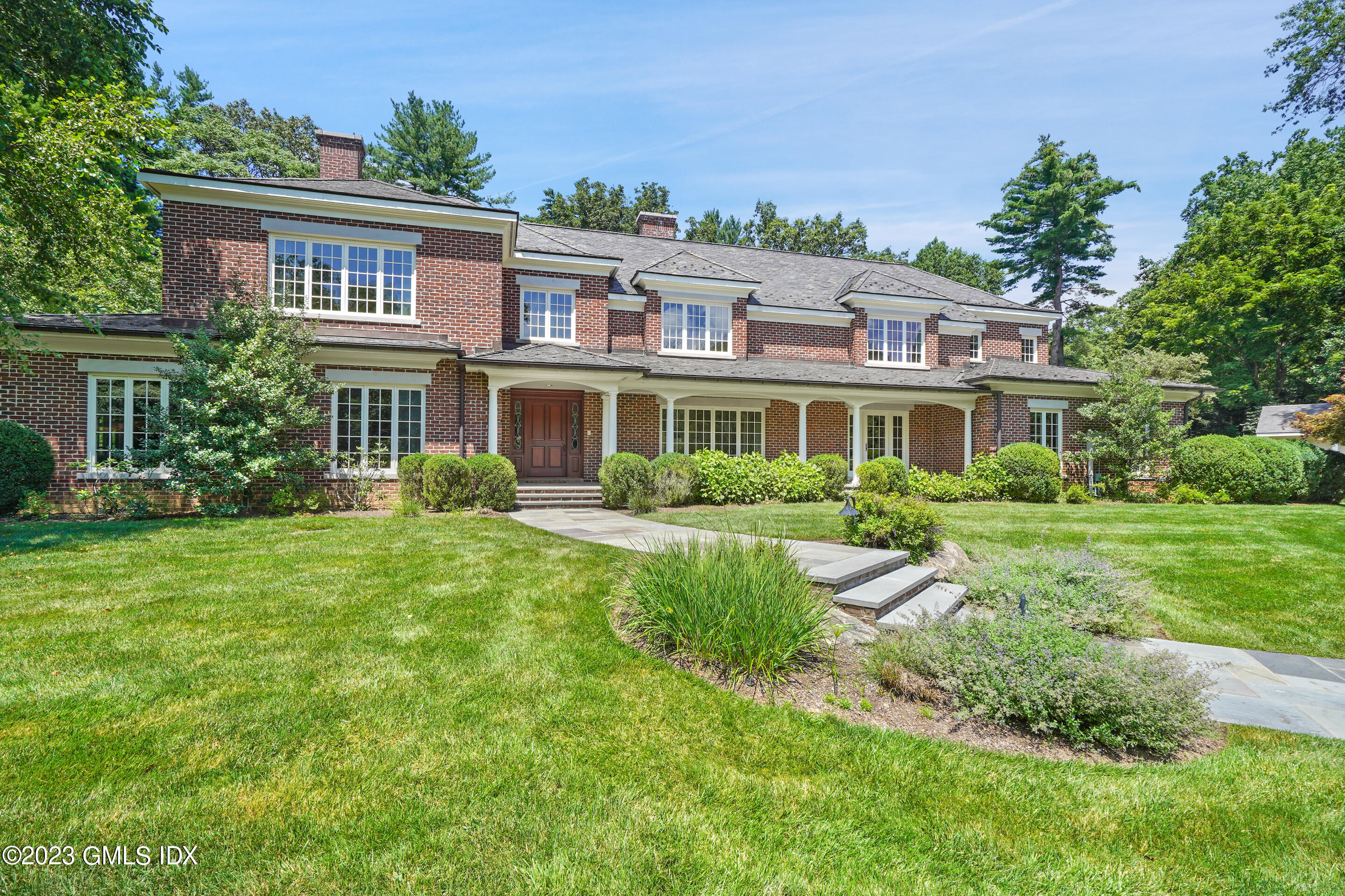 151 Clapboard Ridge Road Greenwich, CT 06831 - Photo 2 of 34 a front view of a house with a yard
