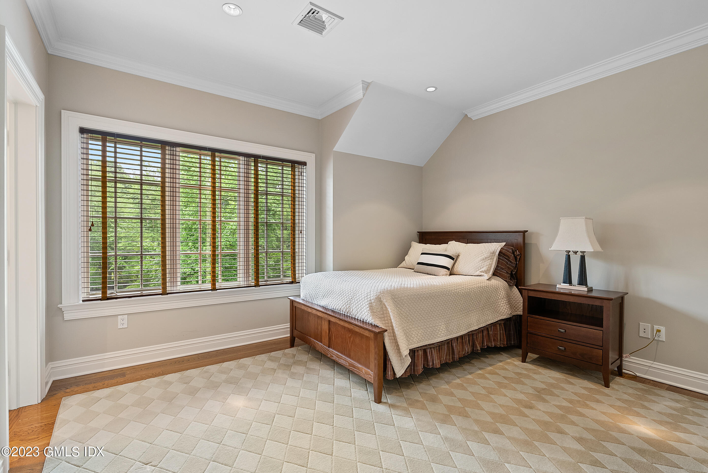 151 Clapboard Ridge Road Greenwich, CT 06831 - Photo 25 of 34 a spacious bedroom with a bed and a large window