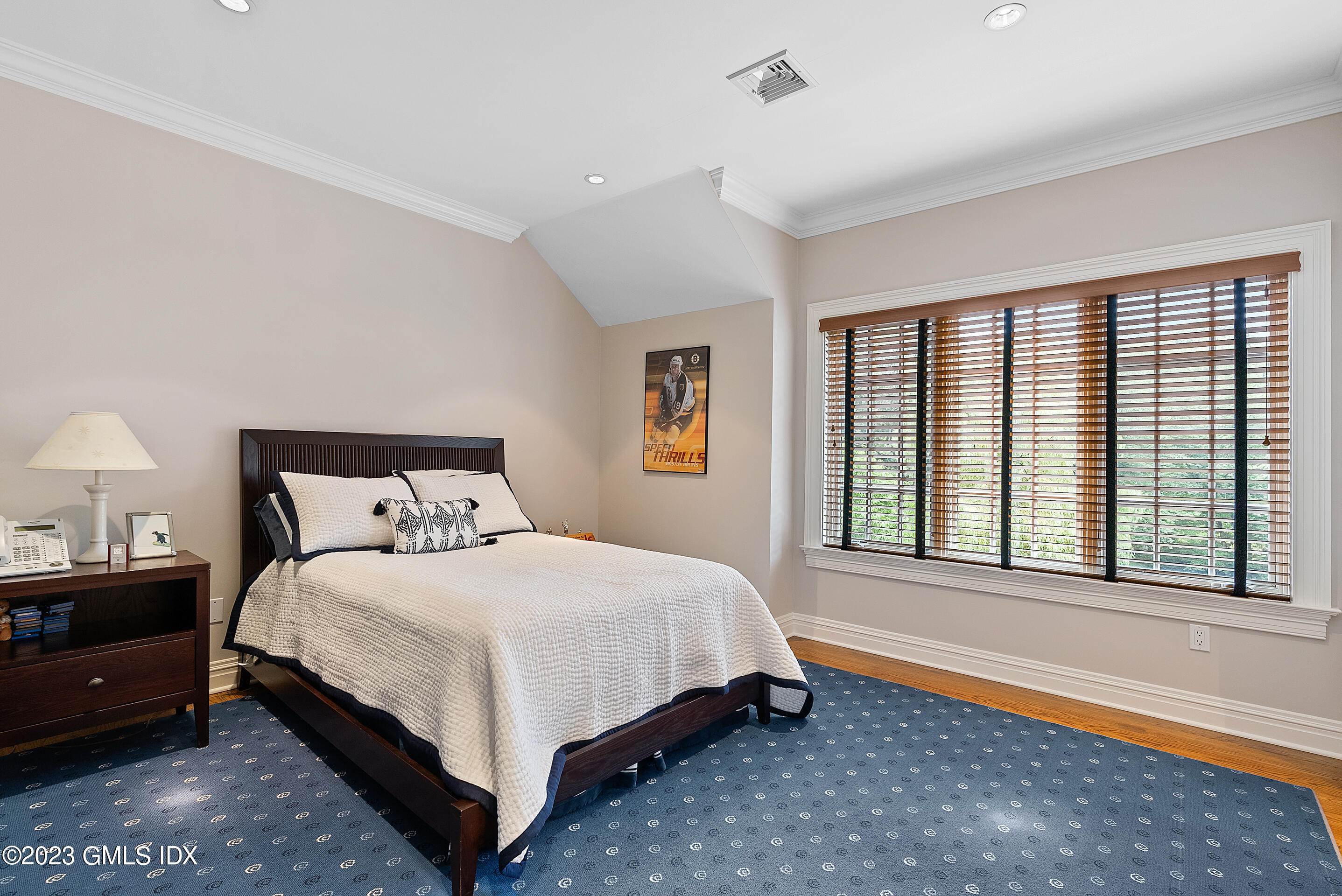 151 Clapboard Ridge Road Greenwich, CT 06831 - Photo 27 of 34 a bedroom with a bed lamp and a large window