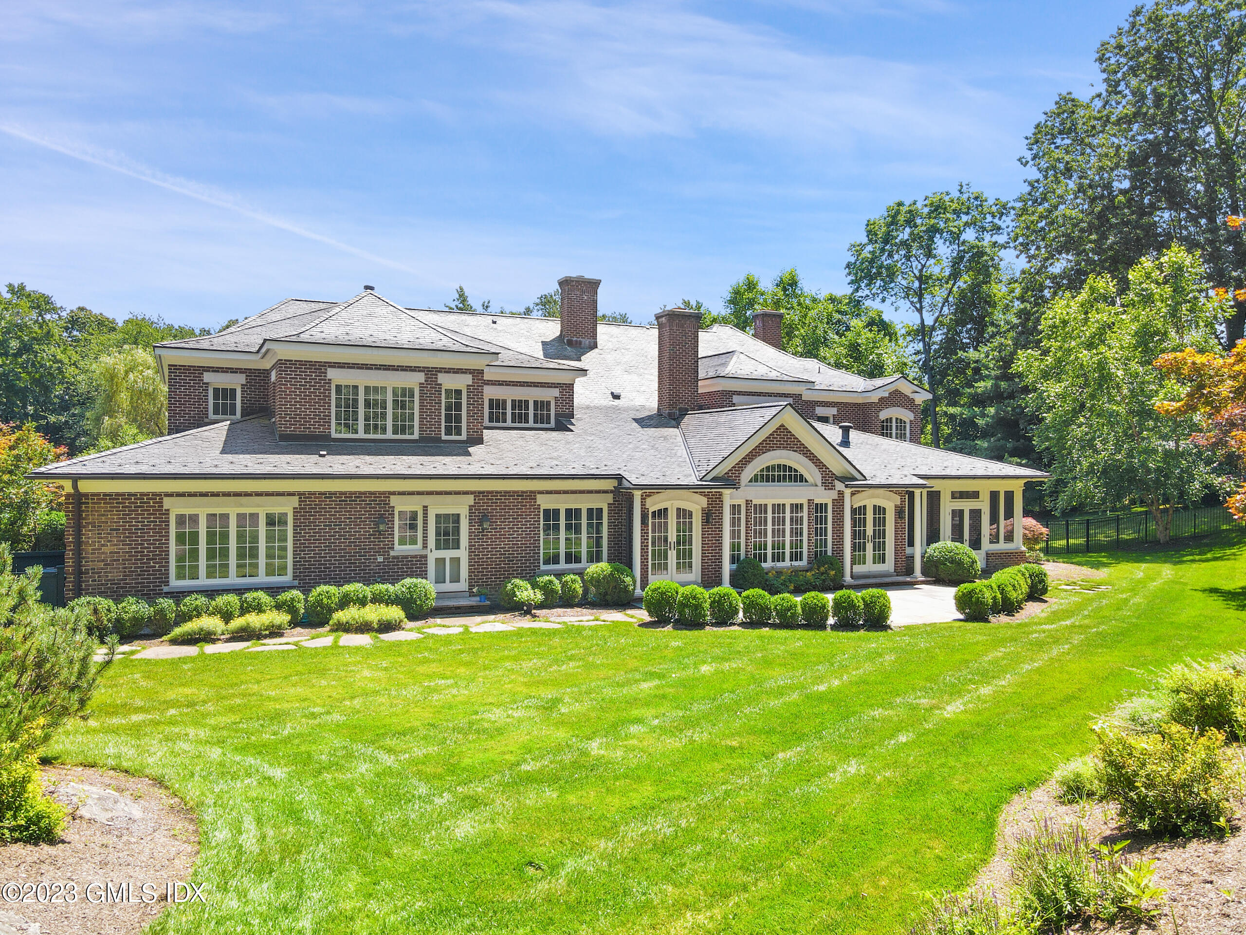151 Clapboard Ridge Road Greenwich, CT 06831 - Photo 29 of 34 a front view of a house with a yard and trees