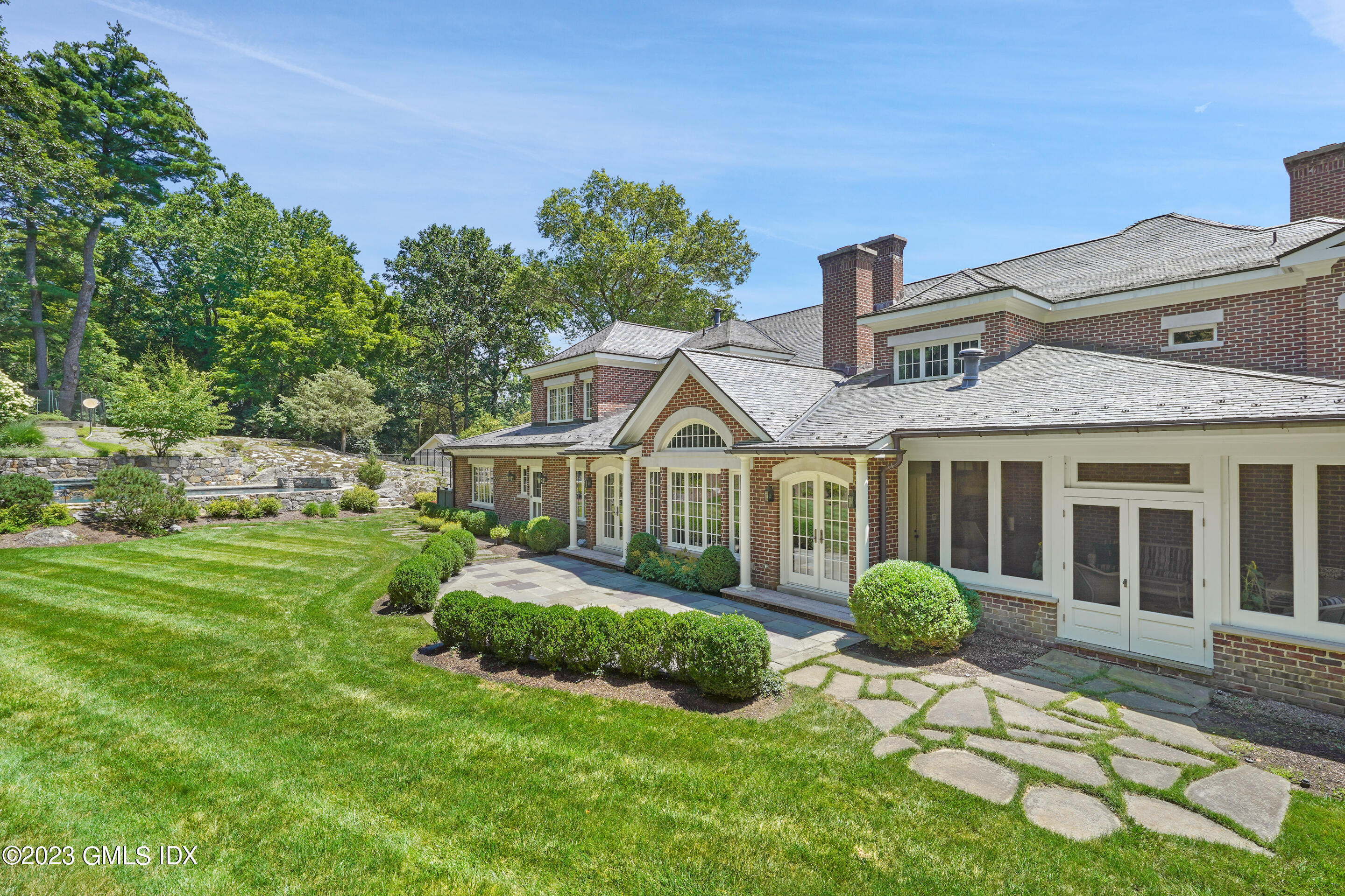 151 Clapboard Ridge Road Greenwich, CT 06831 - Photo 30 of 34 a view of a house with a big yard plants and large trees