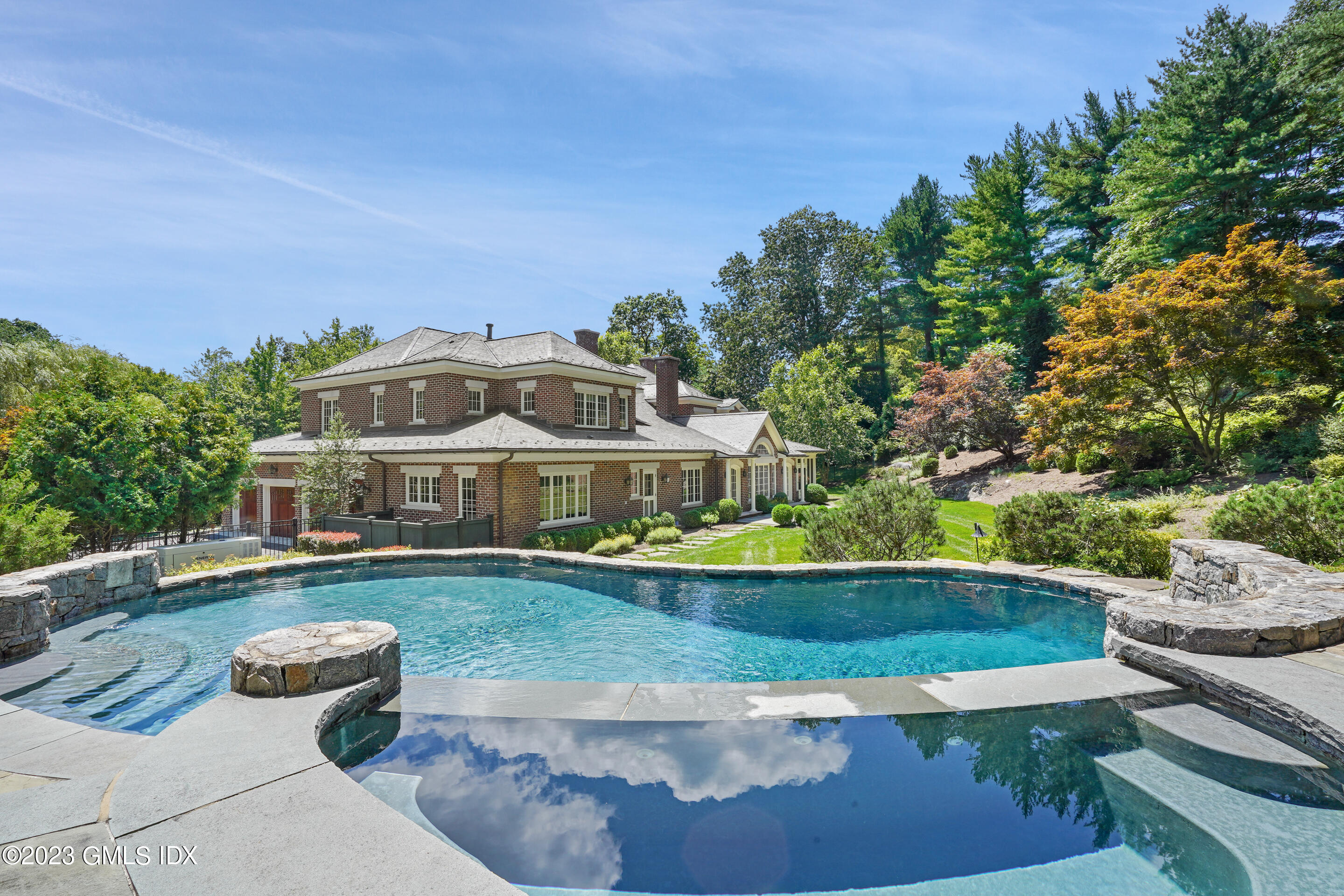 151 Clapboard Ridge Road Greenwich, CT 06831 - Photo 31 of 34 a front view of a house with a yard and potted plants