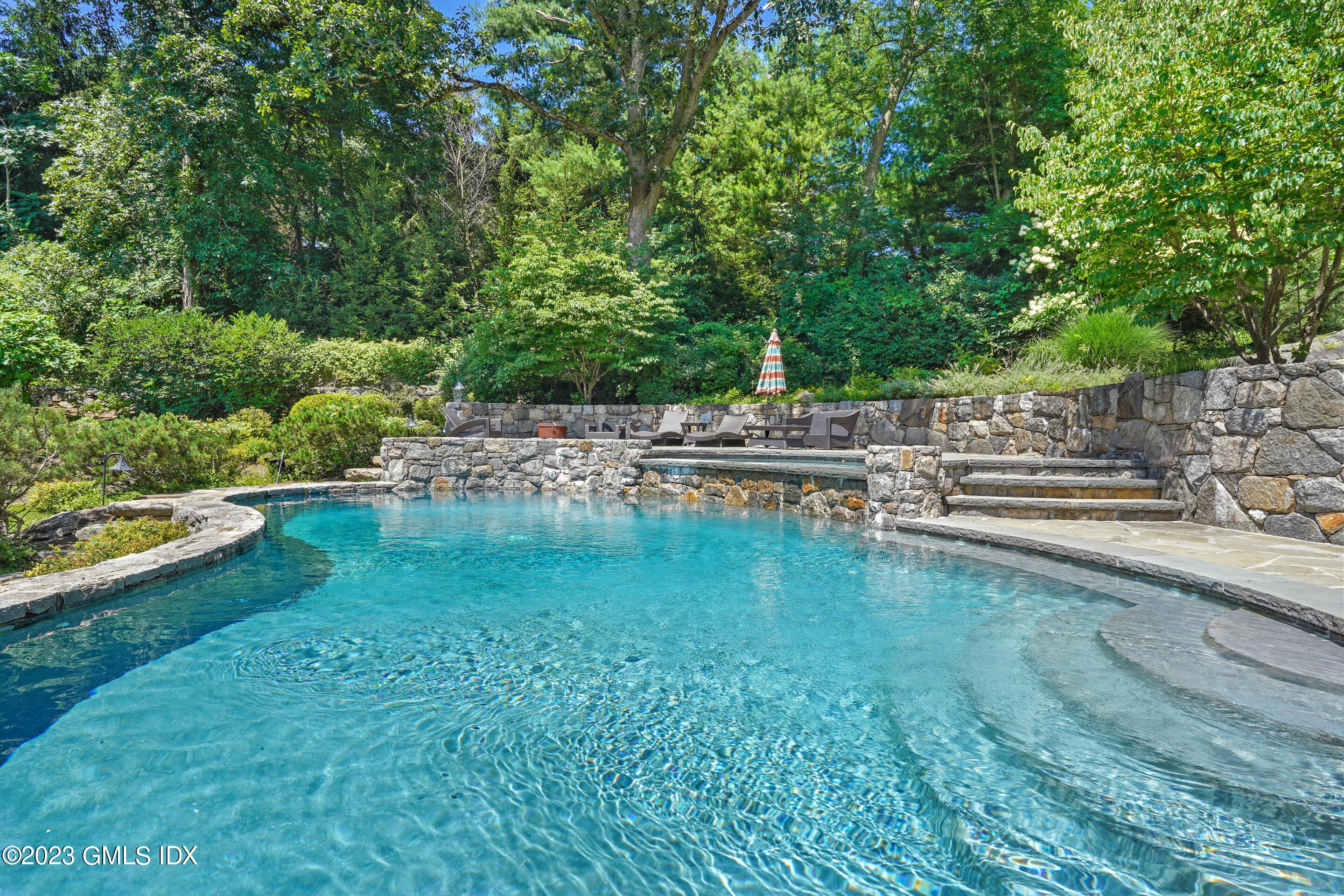 151 Clapboard Ridge Road Greenwich, CT 06831 - Photo 32 of 34 a view of swimming pool with lawn chairs and plants
