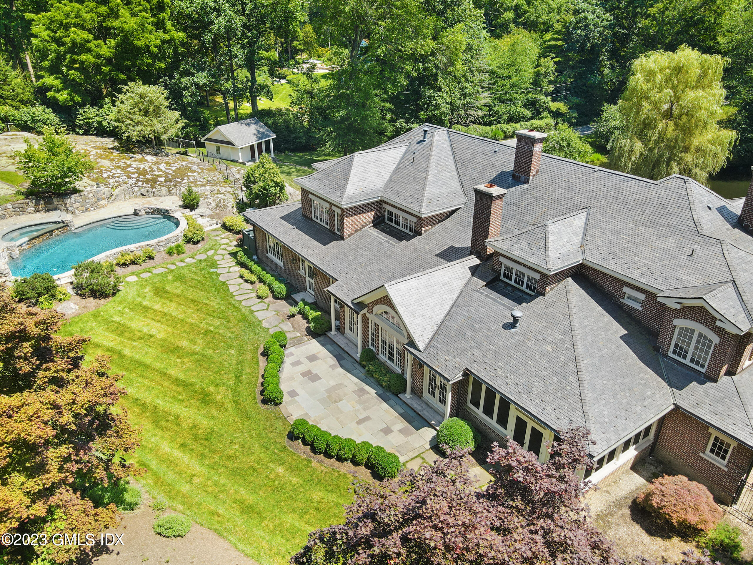 151 Clapboard Ridge Road Greenwich, CT 06831 - Photo 33 of 34 an aerial view of a house with swimming pool and large trees
