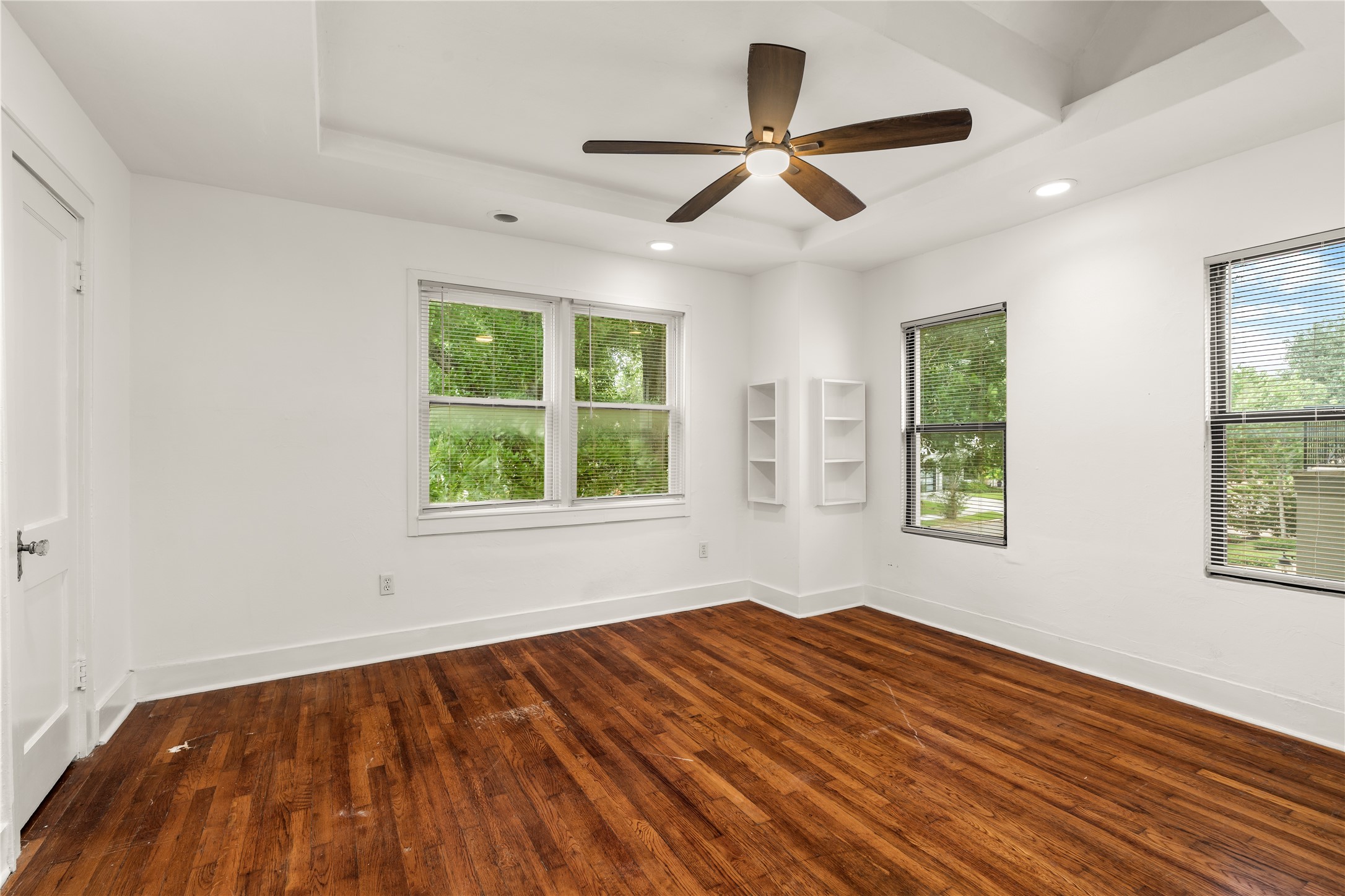 2202 West Main Street Houston, TX 77098 - Photo 20 of 32 a view of empty room with wooden floor and fan