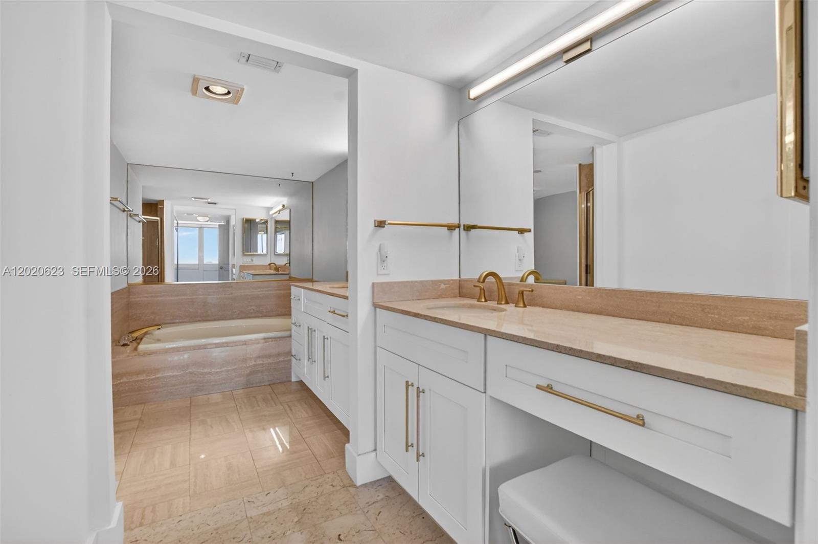 4101 North Ocean Boulevard, Unit 1605 Boca Raton, FL 33431 - Photo 24 of 35 a bathroom with a double vanity sink and a mirror